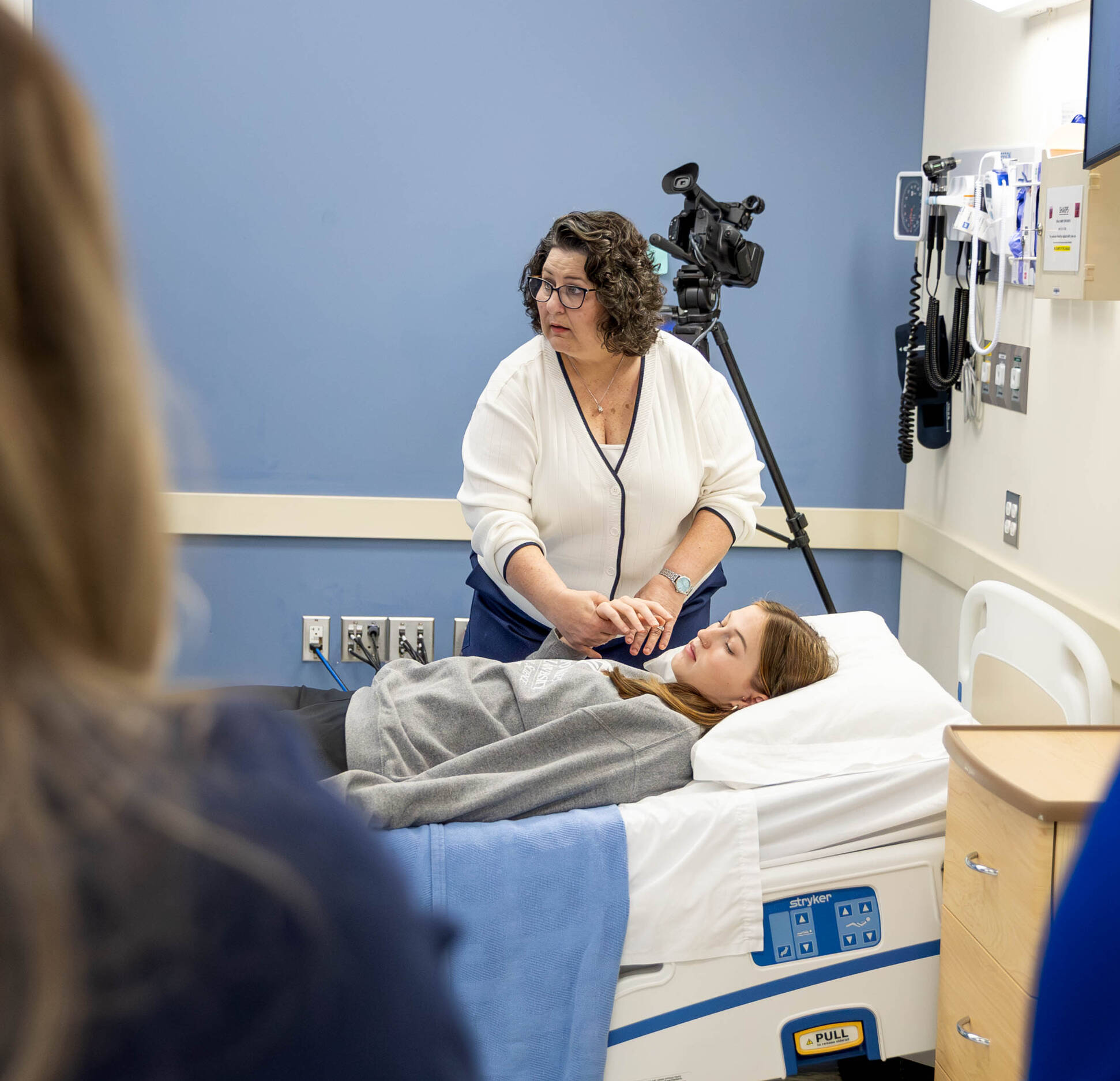 Professor demonstrating procedure with a student